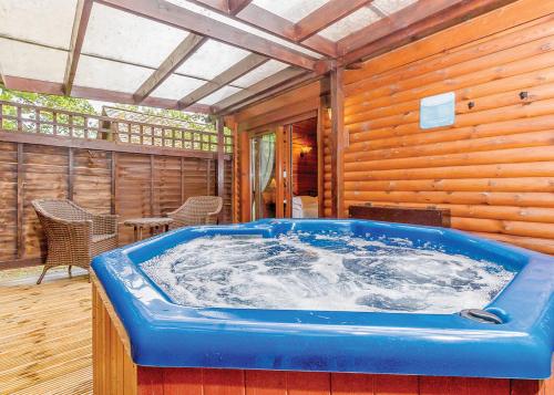 a jacuzzi tub in the middle of a house at Tilford Woods Lodge Retreat in Farnham