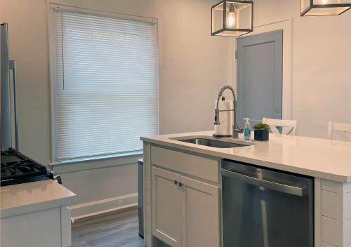 a kitchen with a sink and a window in it at Cozy Campbell Bungalow in Columbus