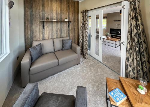 a living room with a couch and a table at Aber Bay Holiday Park in Aberystwyth