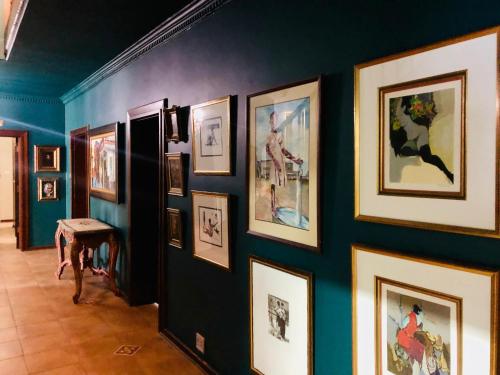 a hallway with a bunch of pictures on a wall at Grafiti Boutique Hotel in Bela-Bela