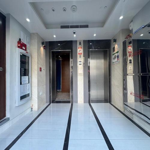 a hallway with a elevator in a building at Premier 2-bedroom Lifeline apartment with free Parking in Abu Dhabi