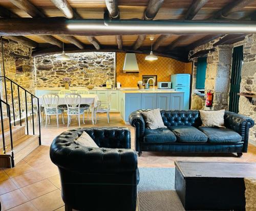 a living room with a couch and a table at Casa Arxemil in Sarria