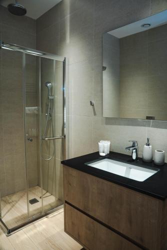 a bathroom with a sink and a shower at 360 Luxury One Bedroom Suite in Nicosia