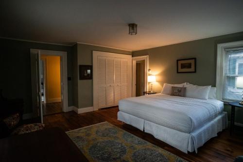 a bedroom with a large white bed in a room at Twin Oaks Near Lake Wallenpaupack Historic Home in Hawley