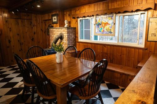 a dining room with a wooden table and chairs at Twin Oaks Near Lake Wallenpaupack Historic Home in Hawley