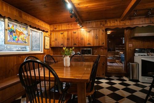 a dining room with a wooden table and chairs at Twin Oaks Near Lake Wallenpaupack Historic Home in Hawley