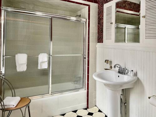 a bathroom with a glass shower and a sink at Twin Oaks Near Lake Wallenpaupack Historic Home in Hawley