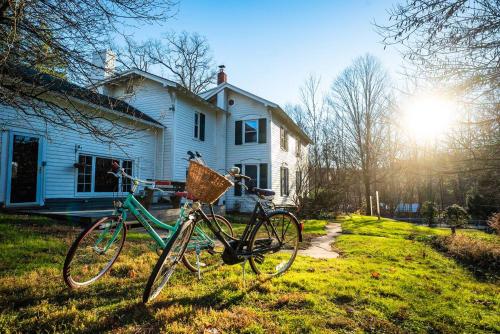 a bike parked in the grass in front of a house at Twin Oaks Near Lake Wallenpaupack Historic Home in Hawley