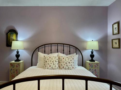 a bedroom with a large bed with two lamps at Twin Oaks Near Lake Wallenpaupack Historic Home in Hawley