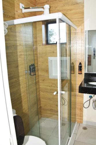 a shower with a glass door in a bathroom at Hotel Internacional Guarulhos in Sao Paulo