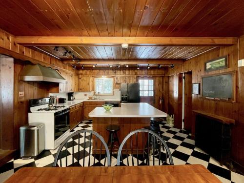 a kitchen with a black and white checkered floor at Twin Oaks Near Lake Wallenpaupack Historic Home in Hawley