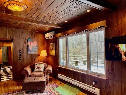 a living room with a chair and a window at Twin Oaks Near Lake Wallenpaupack Historic Home in Hawley