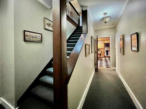 a hallway with a staircase in a house at Twin Oaks Near Lake Wallenpaupack Historic Home in Hawley