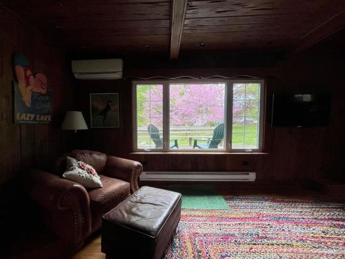 a living room with a couch and a window at Twin Oaks Near Lake Wallenpaupack Historic Home in Hawley