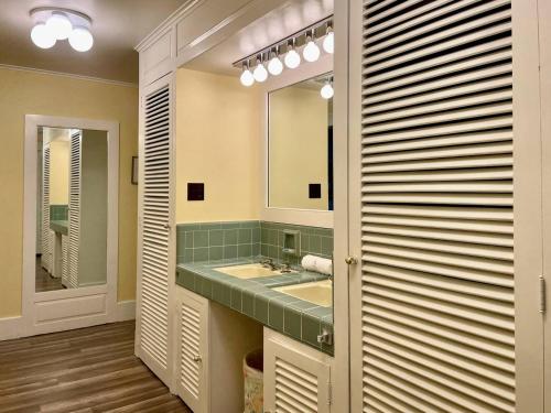 a bathroom with a sink and a mirror at Twin Oaks Near Lake Wallenpaupack Historic Home in Hawley