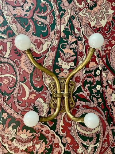 a chandelier hanging from a wall with a pattern at Twin Oaks Near Lake Wallenpaupack Historic Home in Hawley