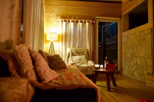a living room with a couch and a chair at Juralodgespa Détente avec jacuzzi et vue in Courrendlin