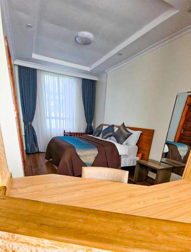 a hotel room with a bed and a window at The Lantern Gardens - Oloirien in Kiserian