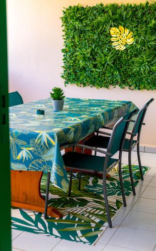 a table and chairs with a blue tablecloth on it at Emeraude & Lagon in Pointe-à-Pitre