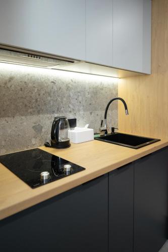 a kitchen with a sink and a counter top at Апартаменти MYFREEDOM поруч із метро Васильківська in Kyiv