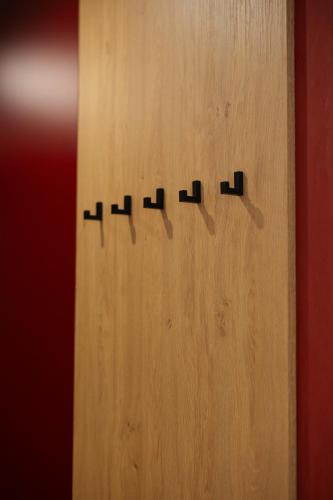 a wooden door with four black handles on it at Апартаменти MYFREEDOM поруч із метро Васильківська in Kyiv
