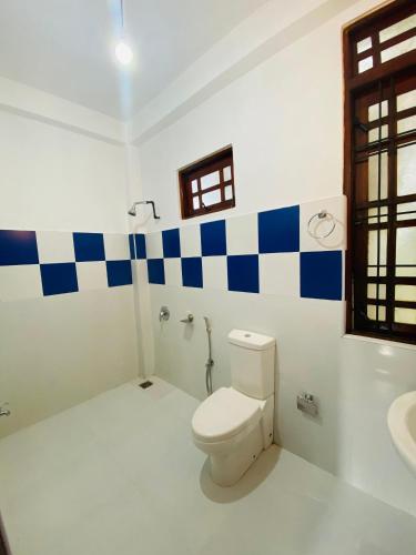 a bathroom with a toilet and a sink at Sudumal Cottage in Ella