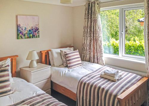 Ένα ή περισσότερα κρεβάτια σε δωμάτιο στο Langmere Lakes Lodges
