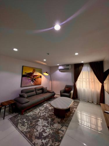a living room with a couch and a table at Abuja City Tourist's Home in Abuja