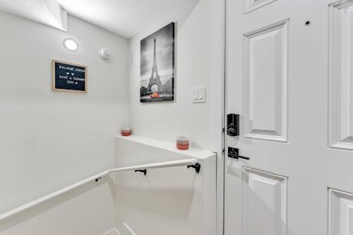 a white room with a staircase and a door at New Builtspacious Suite Bsmtgamesnetflix in Edmonton