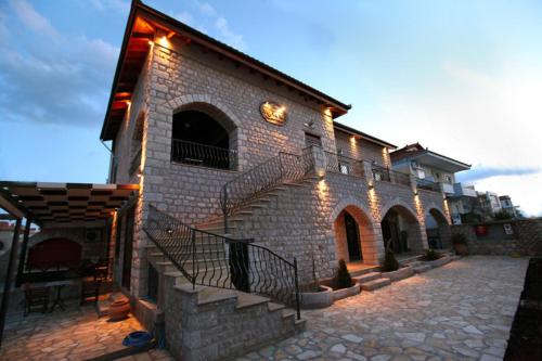 a brick building with stairs and lights on it at Myral Guesthouse in Nafplio
