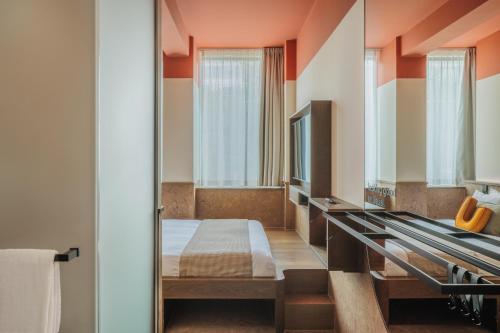 a hotel room with a bed and a mirror at The Usual Rotterdam in Rotterdam