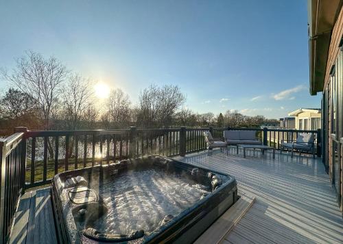 a hot tub on the deck of a house at Watermill Leisure Park in Moortown