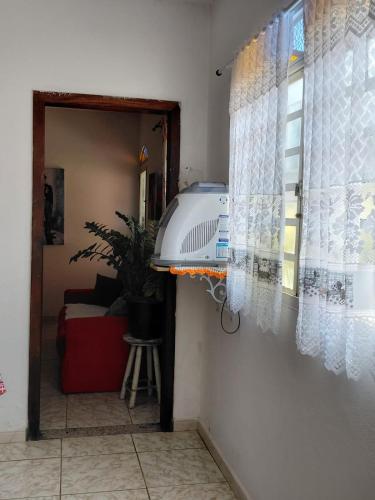 a view of a room with a window and a couch at hostel da Eide - Inhotim in Brumadinho