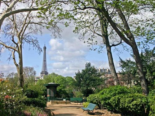a park with the eiffel tower in the background at Mercure Paris Tour Eiffel Pont Mirabeau in Paris