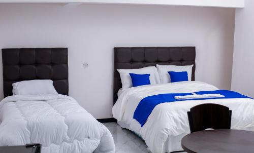 En eller flere senge i et værelse på Salama Blue Lodge