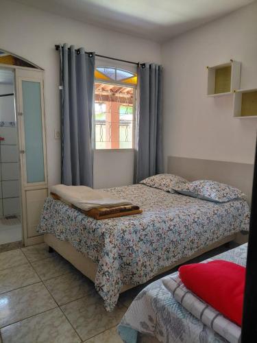 a bedroom with two beds and a window at hostel da Eide - Inhotim in Brumadinho
