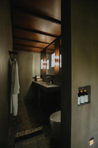 a bathroom with a sink and a toilet at Mémé Villa Siargao in General Luna