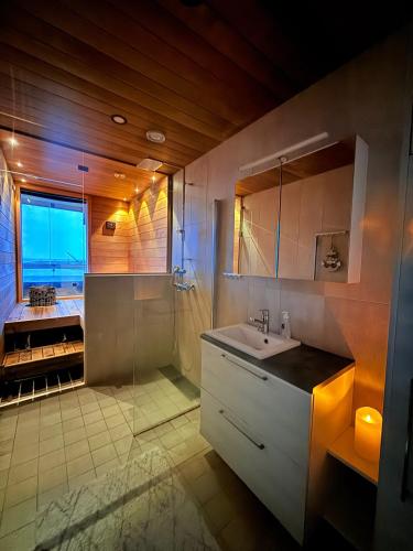 a bathroom with a sink and a shower at Marina Resort A8 in Kalajoki