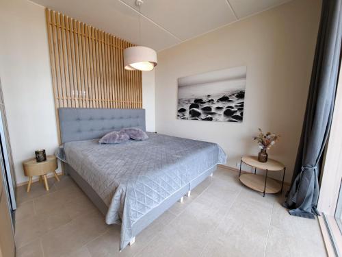 a bedroom with a bed and a picture of sheep at Marina Resort A8 in Kalajoki