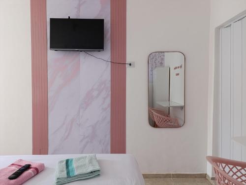 a room with a table and a mirror on a wall at Apartamento Privativo com Vaga in São Bernardo do Campo