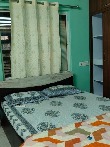 a bedroom with a bed with pillows and a mirror at Neon Ventures Comfort Stay in Kolkata