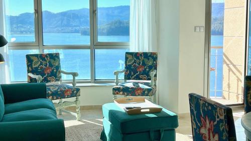 a living room with two chairs and a table at The Cliffs - Ortigueira Kalmak in Santa Marta de Ortigueira