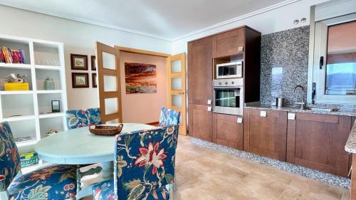 a kitchen with a table and chairs in a room at The Cliffs - Ortigueira Kalmak in Santa Marta de Ortigueira