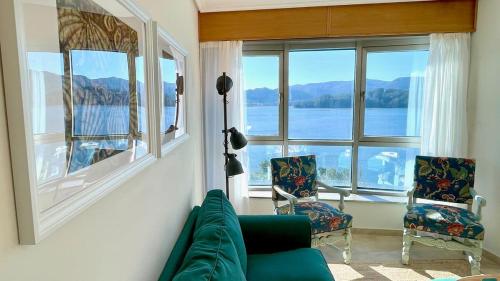 a living room with a couch and two chairs at The Cliffs - Ortigueira Kalmak in Santa Marta de Ortigueira