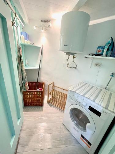 a laundry room with a washing machine in it at The Cliffs - The Painted Mill in O Barqueiro