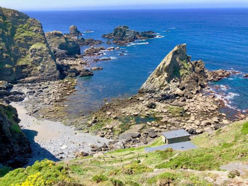 a view of a rocky coastline with the ocean at The Cliffs - The Painted Mill in O Barqueiro
