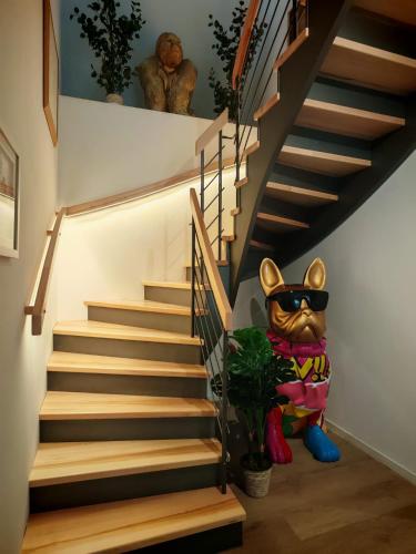 a staircase with a cat statue standing next to it at Chalet NATURTRAUM in Runkel