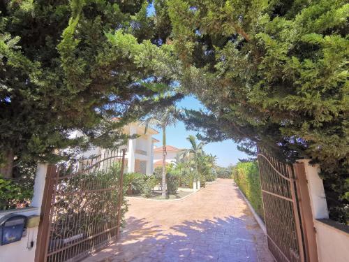 a gate to a house with a driveway at Orchard Blossom Private Villa With Pool in Phrenaros