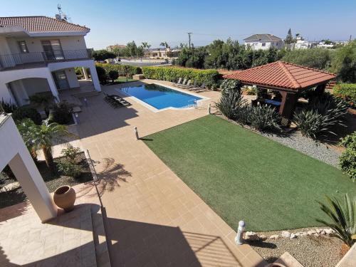 an aerial view of a yard with a swimming pool and a house at Orchard Blossom Private Villa With Pool in Phrenaros