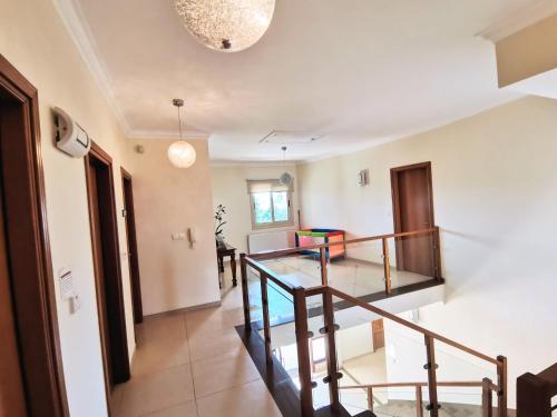 a hallway with a staircase in a house at Orchard Blossom Private Villa With Pool in Phrenaros